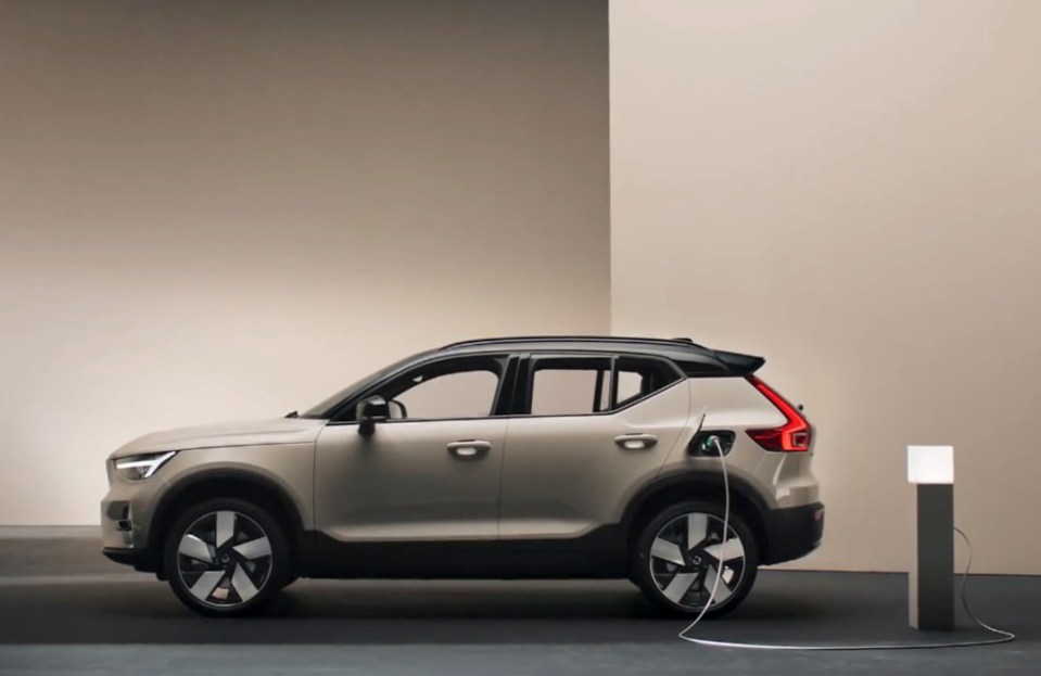 A beige Volvo EX40 electric SUV charging.
