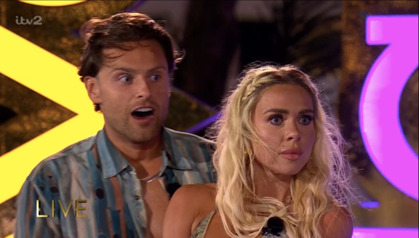 Screenshot of a man and woman looking surprised during a live TV show.