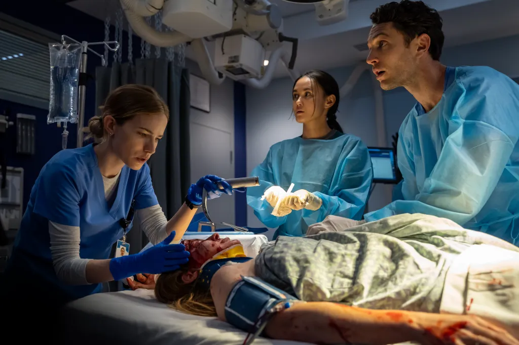 Still from a medical drama showing medical professionals attending to a patient.