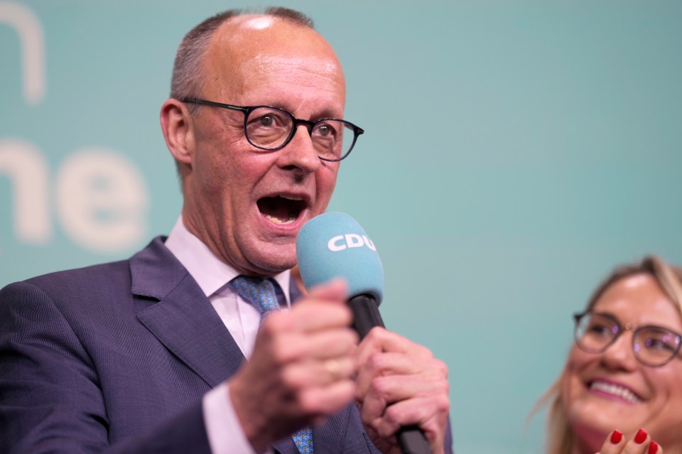 Friedrich Merz, a candidate for the Christian Democratic Union party, speaking into a microphone.