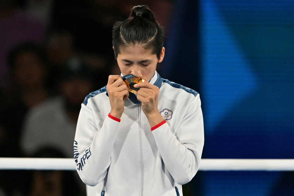 Taiwan's Lin Yu-ting kissing her gold medal at the Olympic Games.