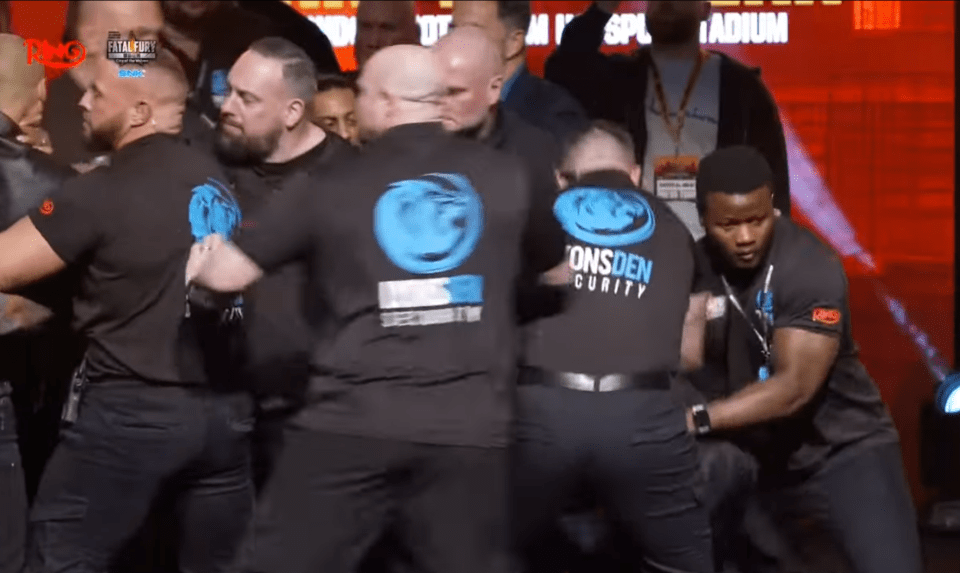 Security guards subduing a person.