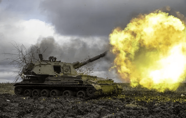 Self-propelled howitzer firing.