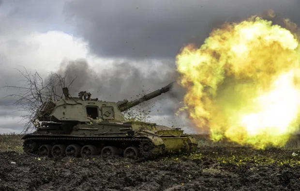 Self-propelled howitzer firing.