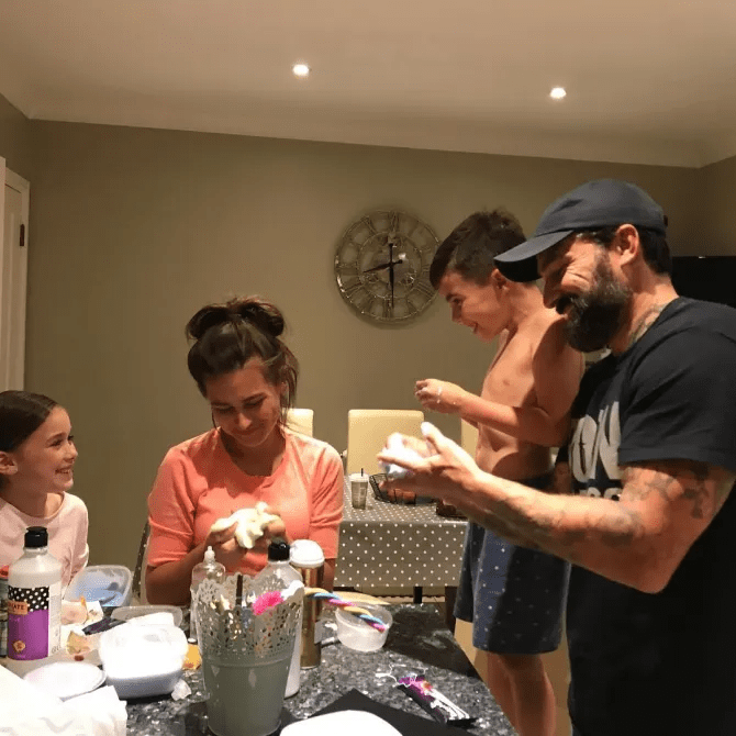 Family making crafts together at a table.