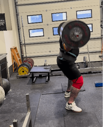 Person performing a barbell deadlift.