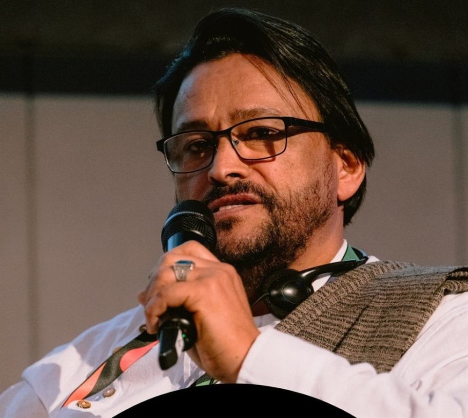 Man speaking into a microphone.