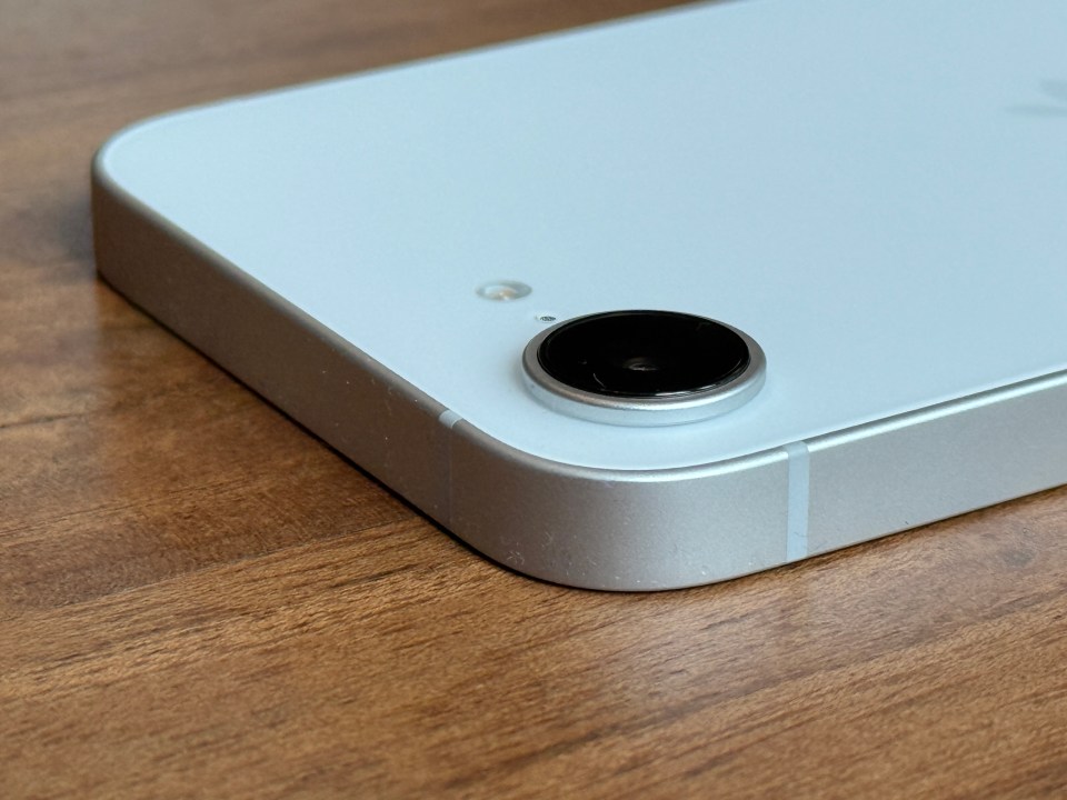 Close-up of a light blue smartphone's camera lens.