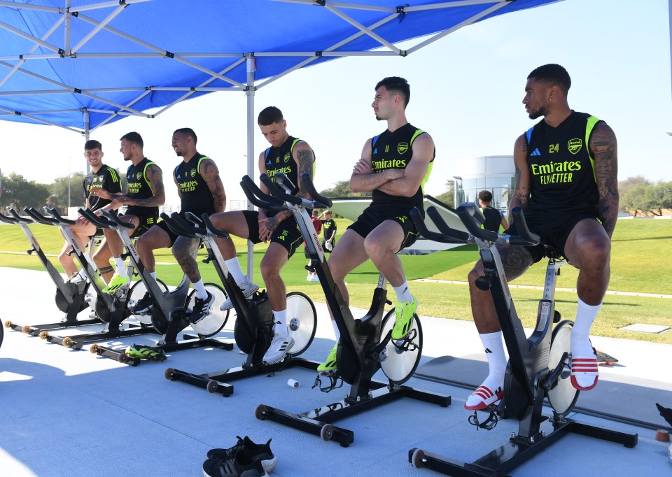 Arsenal soccer players on stationary bikes during training.