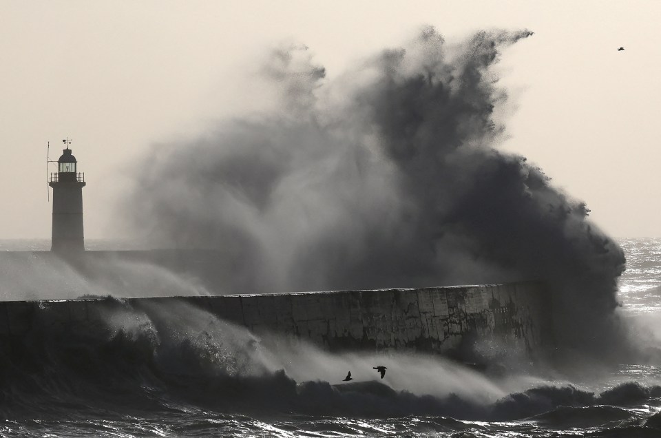 People battling strong winds and rain in London.