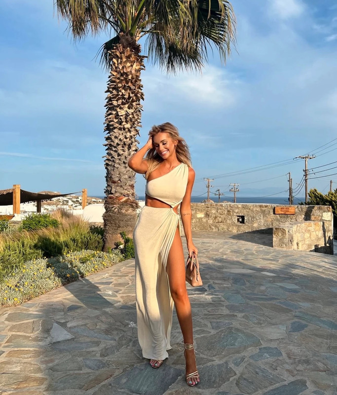 Laura Anderson wearing a beige cutout maxi dress.