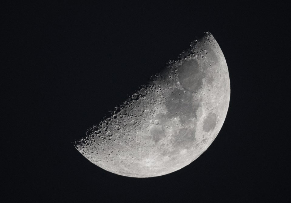 Crescent moon with craters visible.