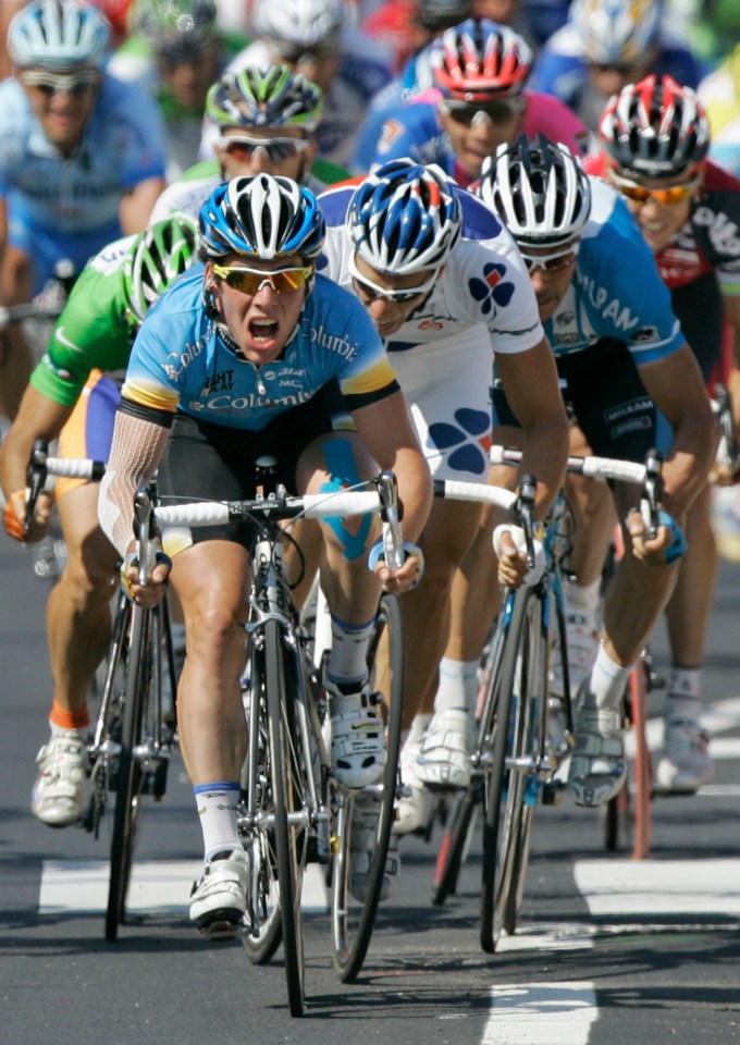 Mark Cavendish grimacing while sprinting to win a Tour de France cycling race.