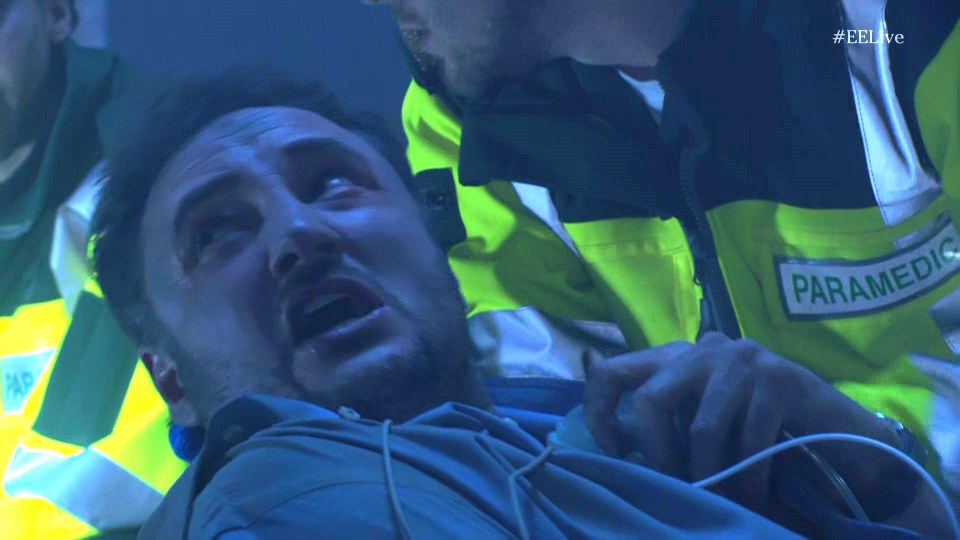 A man receiving medical attention from a paramedic.