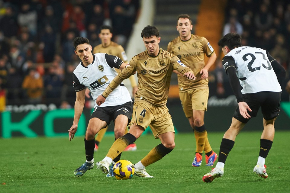 Martin Zubimendi of Real Sociedad dribbling the ball during a soccer match.