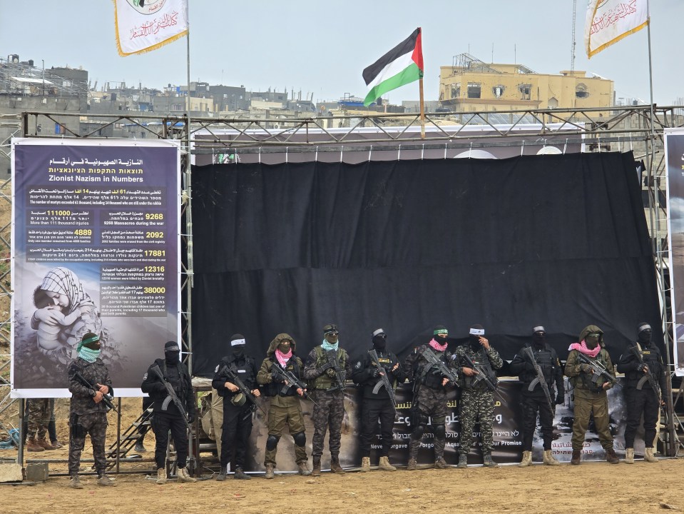 Al-Qassam Brigades members stand guard at a ceremony in Gaza.