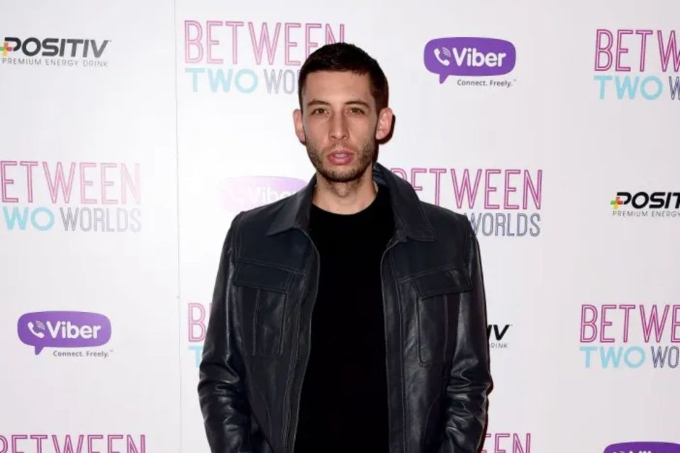 Man in black leather jacket at Between Two Worlds premiere.