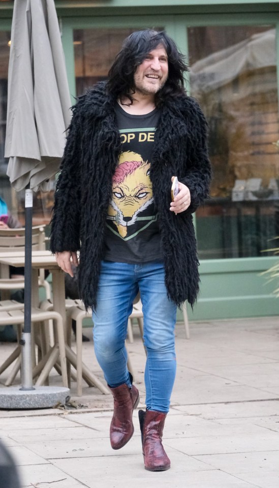 Noel Fielding walking down the street.