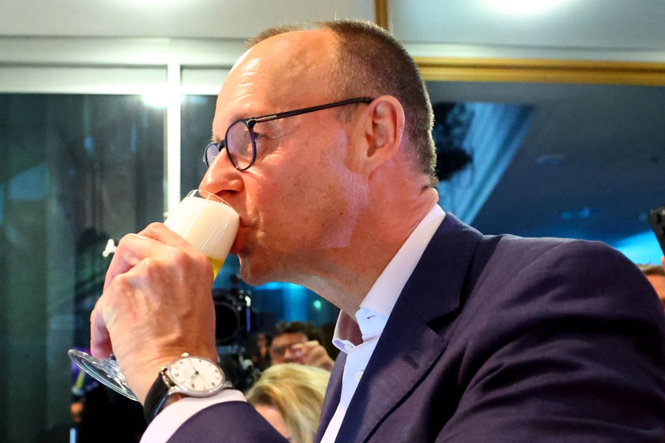 Friedrich Merz drinking beer after election results.