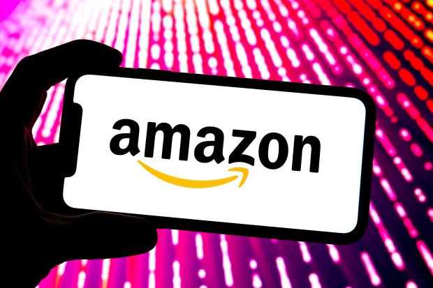 Photo illustration of the Amazon logo on a smartphone screen.