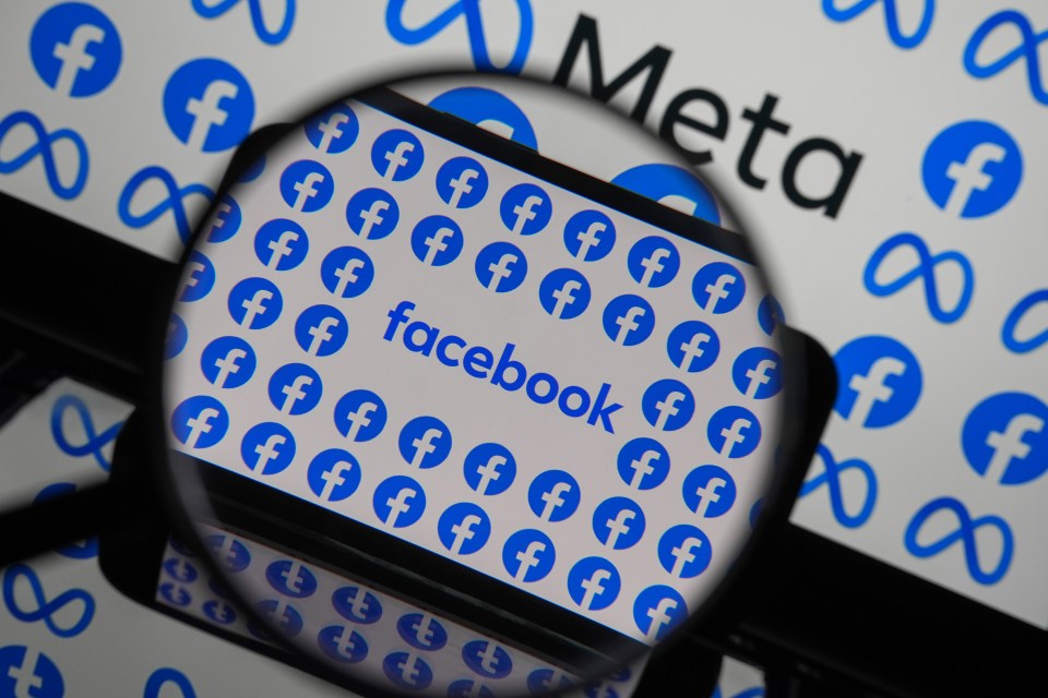 Photo illustration of Facebook logos on a phone screen viewed through a magnifying glass.