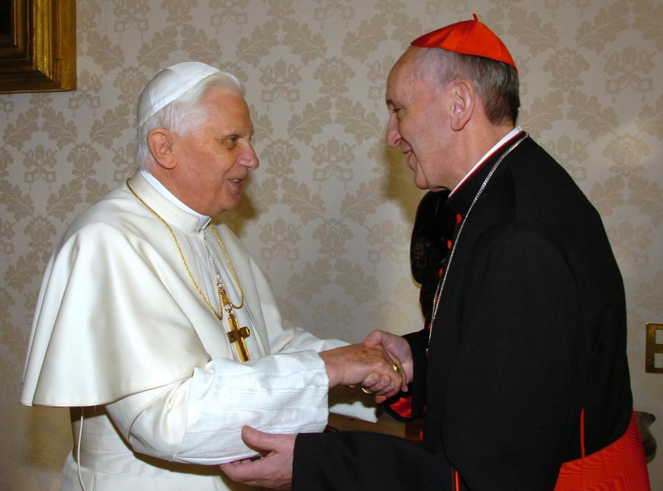 Pope Benedict XVI shaking hands with Cardinal Jorge Mario Bergoglio.