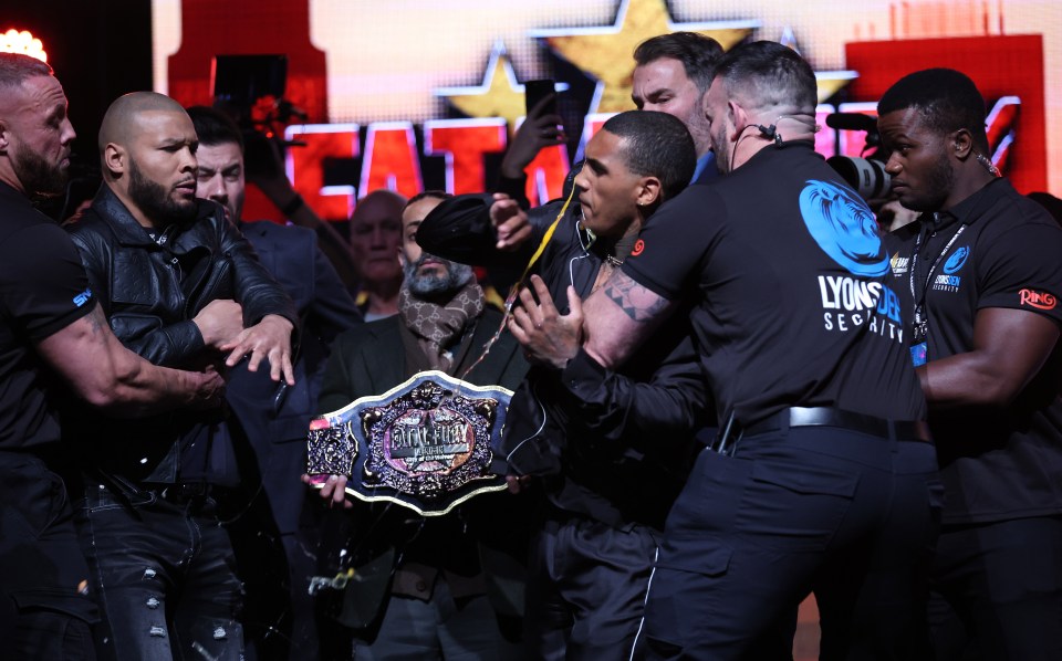 Conor Benn being held back after Chris Eubank Jr. threw an egg at him during a press conference.