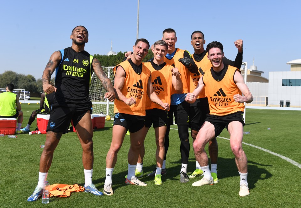 Arsenal players celebrating during a training session.