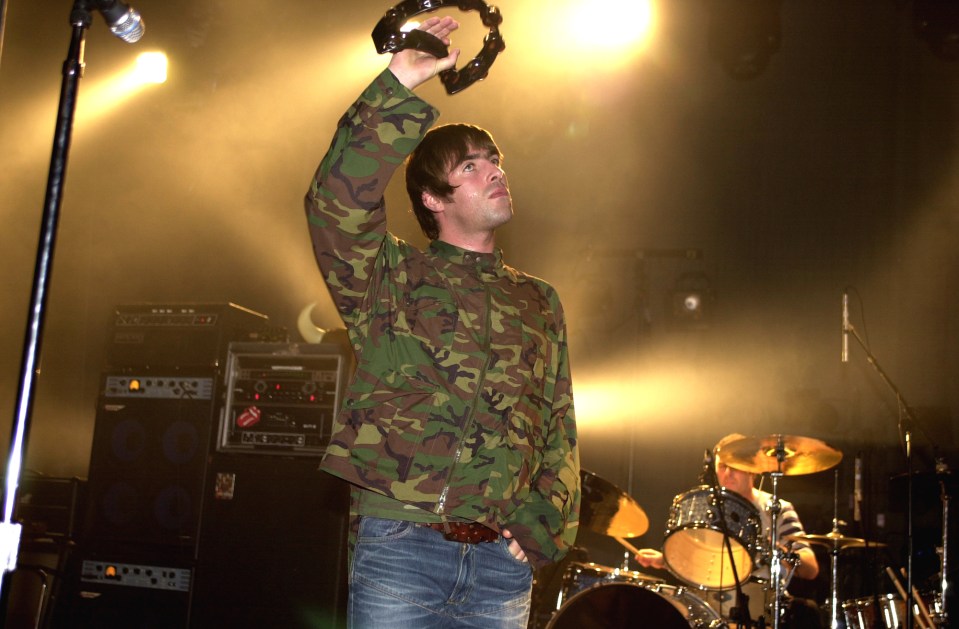 Oasis' Liam Gallagher performing on stage.
