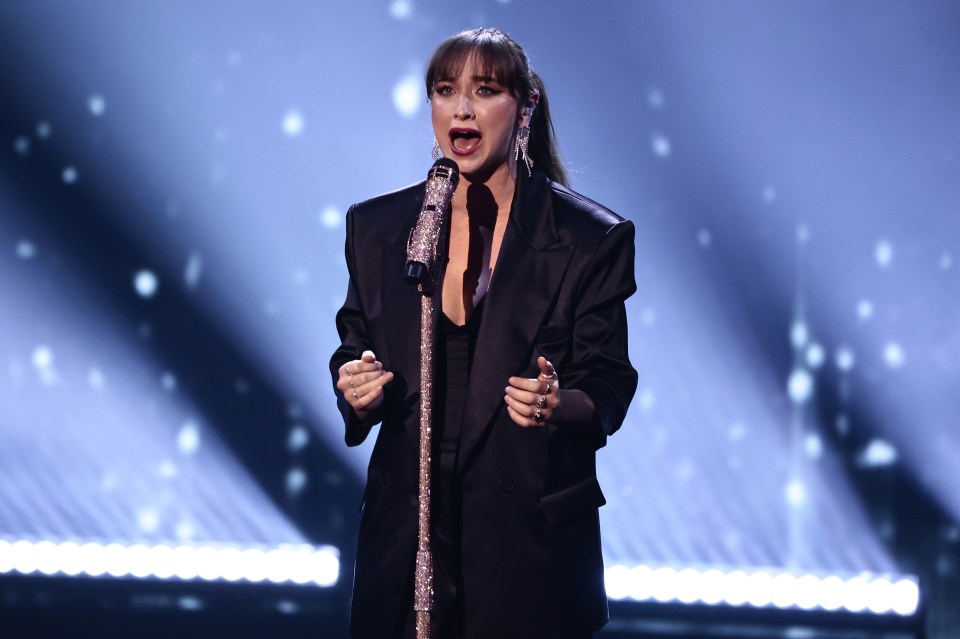 Singer performing on stage.