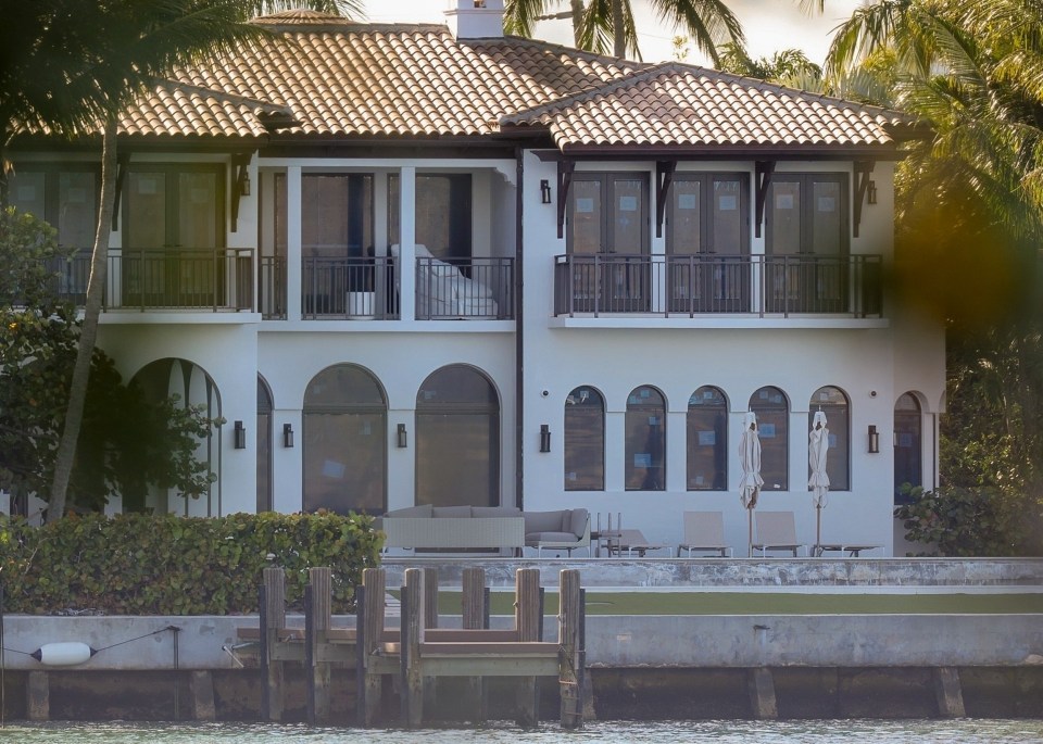 Andrew Tate looking at a waterfront property.