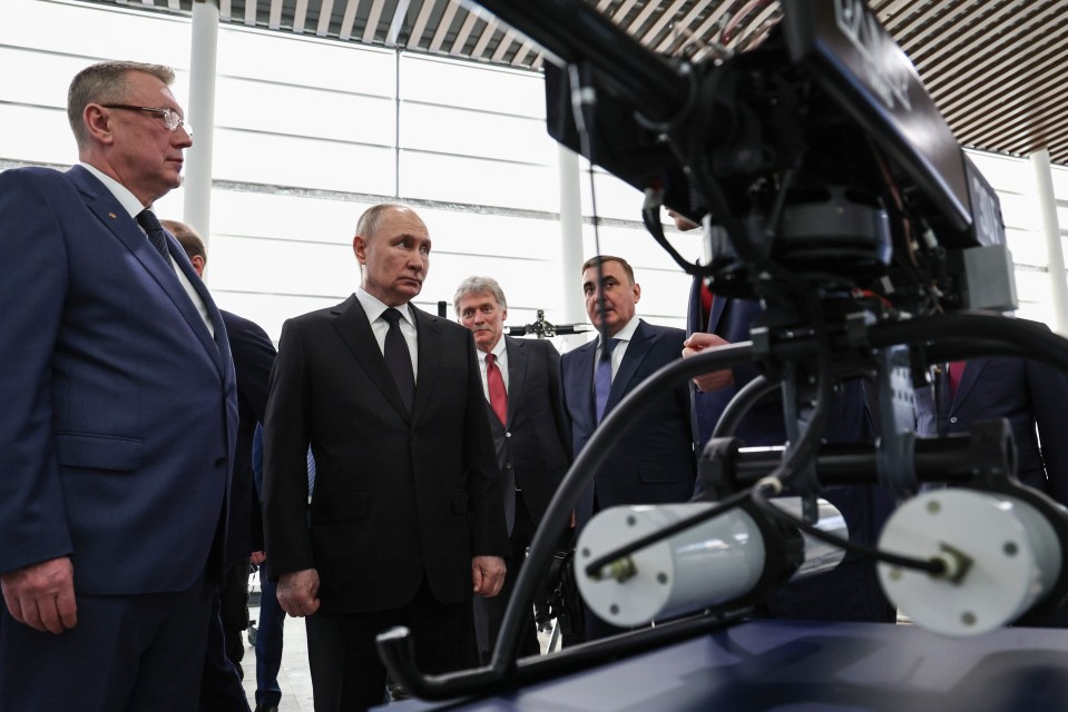 Vladimir Putin and other officials viewing radar technology.