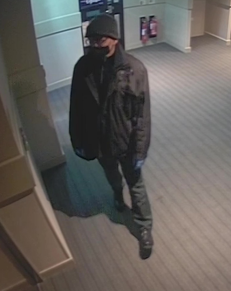 Screen grab of a man wearing a face mask and gloves.