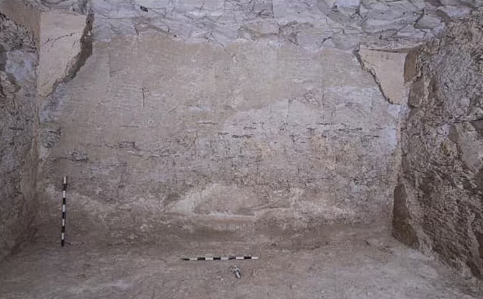 Tomb corridor with plaster floor and wall.