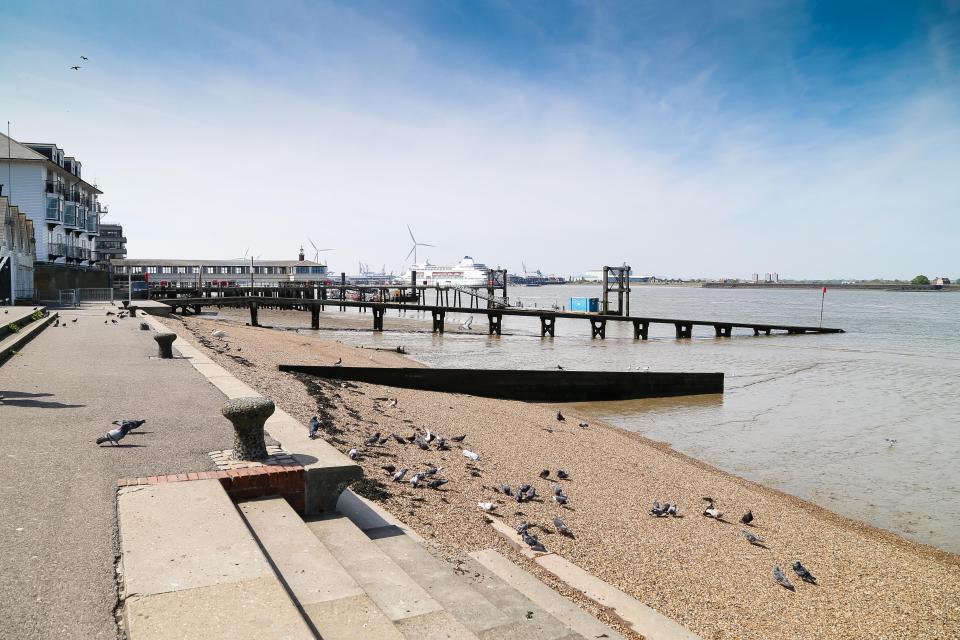 View of Gravesend Promenade overlooking a cruise liner moored in Tilbury.
