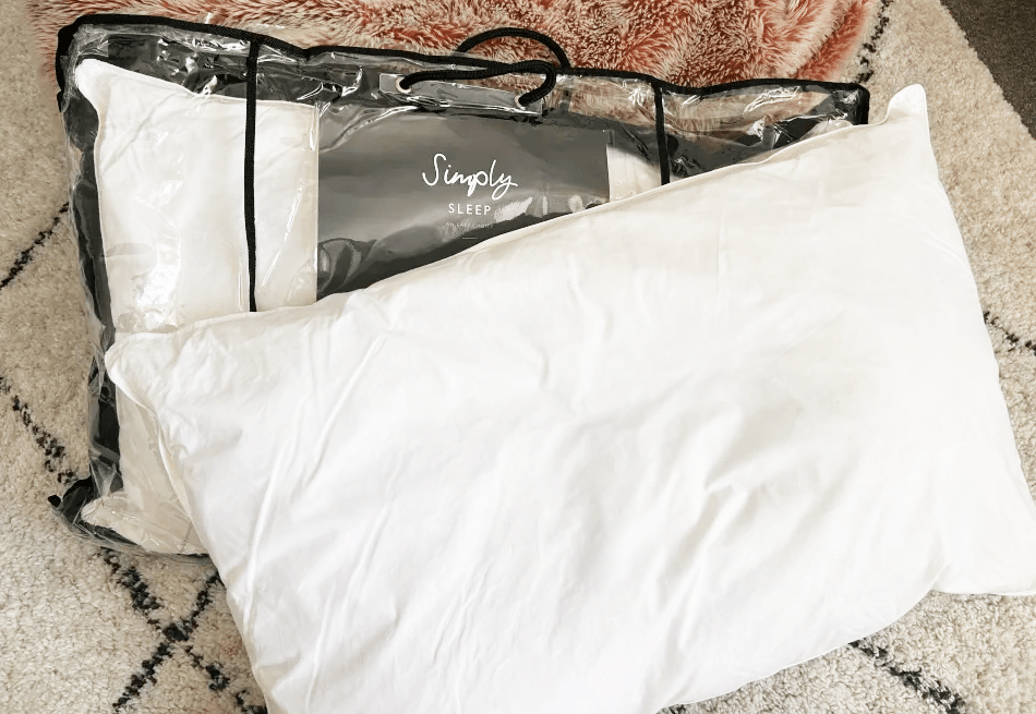 Two Simply Sleep pillows in plastic packaging.