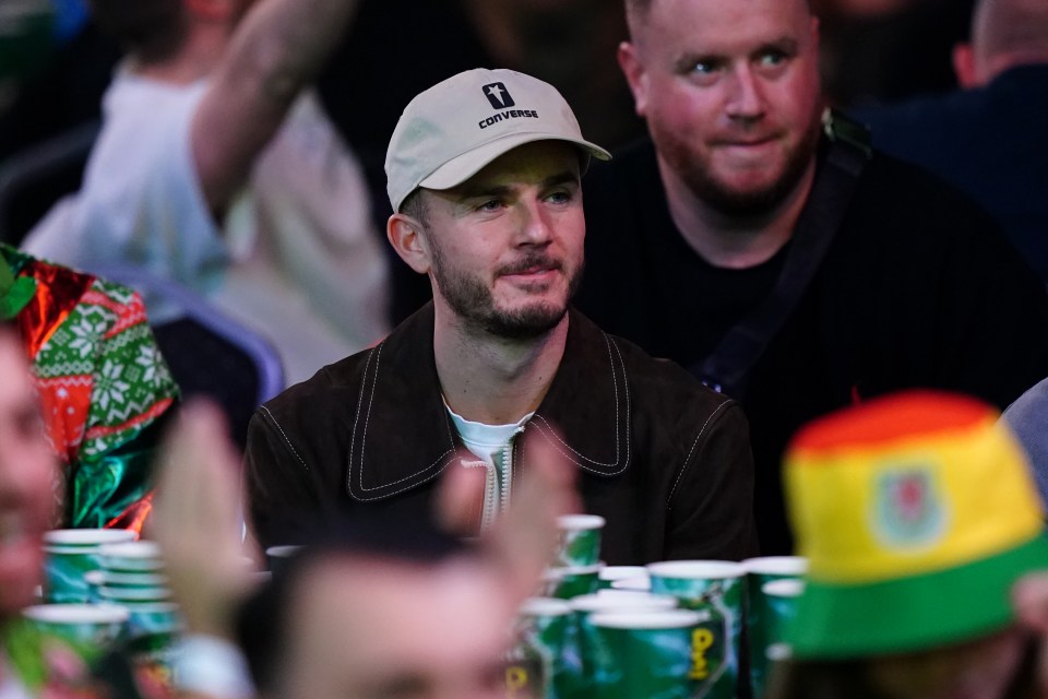 James Maddison, Tottenham Hotspur player, watching a darts match.