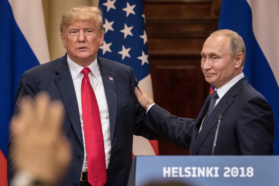 President Trump and President Putin shaking hands at a press conference.