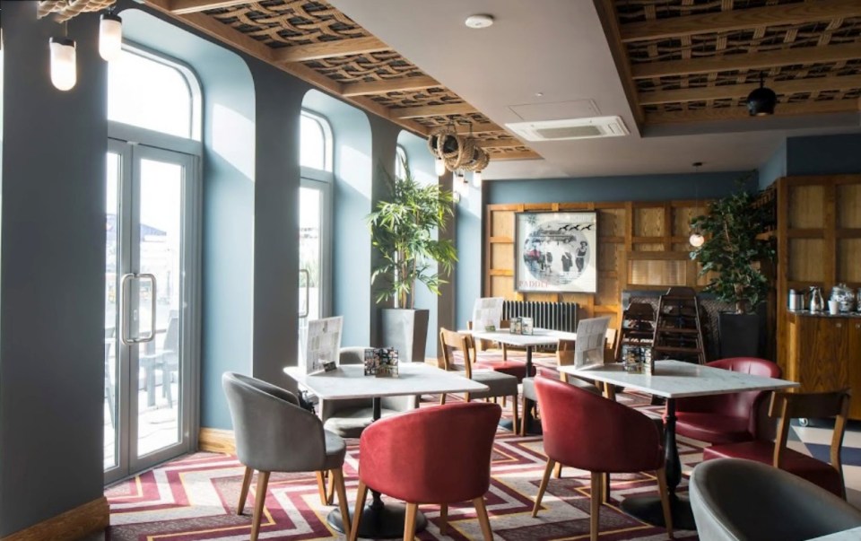 Interior of a Wetherspoon's pub with tables and chairs.