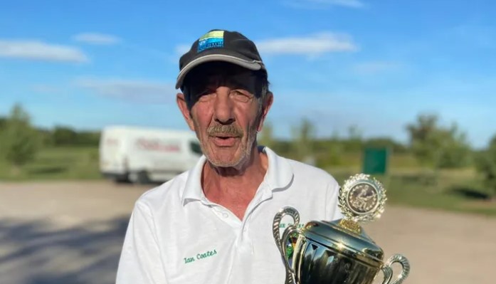 Ian Coates holding a trophy.