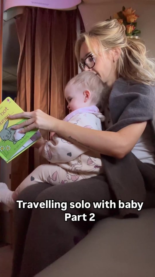 Woman reading to baby on airplane.