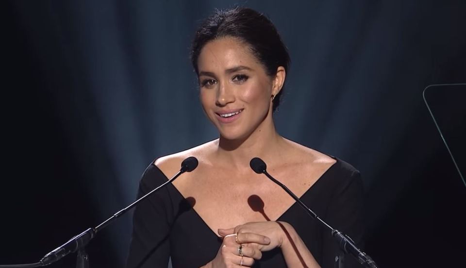 Meghan Markle giving a speech at a podium.