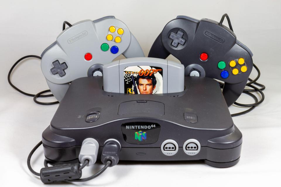 Nintendo 64 console with GoldenEye 007 game cartridge and two controllers.