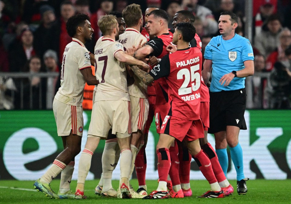 Soccer players in a scuffle, with a referee intervening.