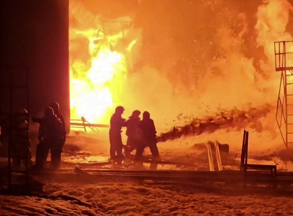 Firefighters extinguishing an oil depot fire.