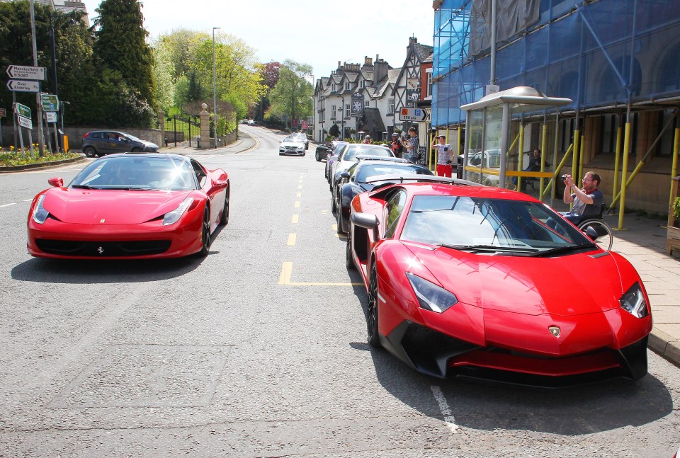 Red supercars parked on a street.