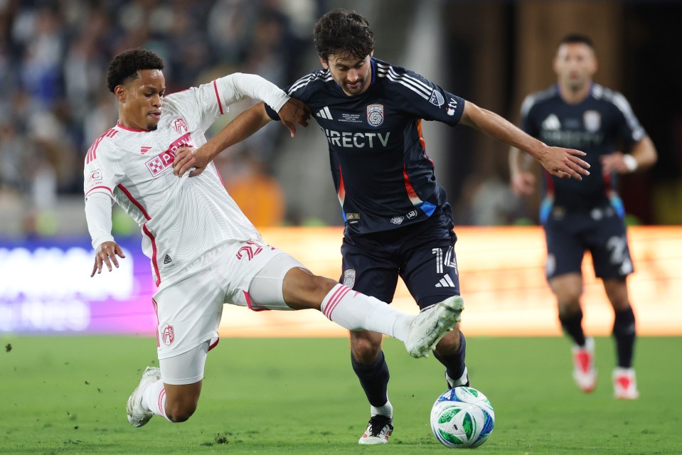 Soccer players battling for the ball.