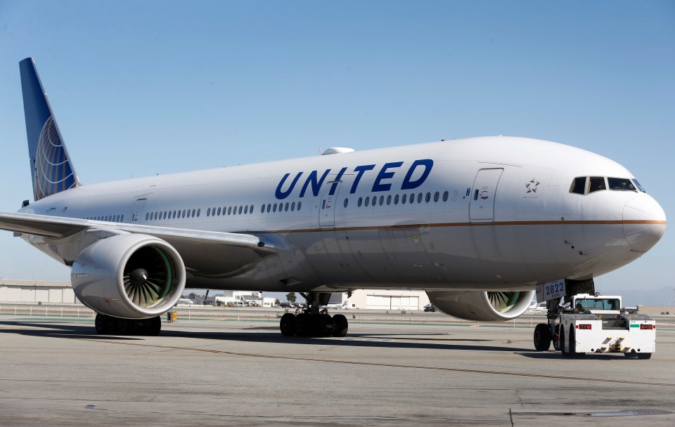 United Airlines plane being pushed back from the gate.