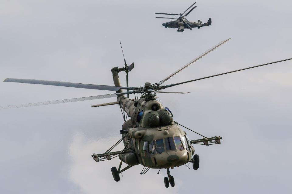 Russian Air Force Mil Mi-8 and Kamov Ka-52 helicopters flying.