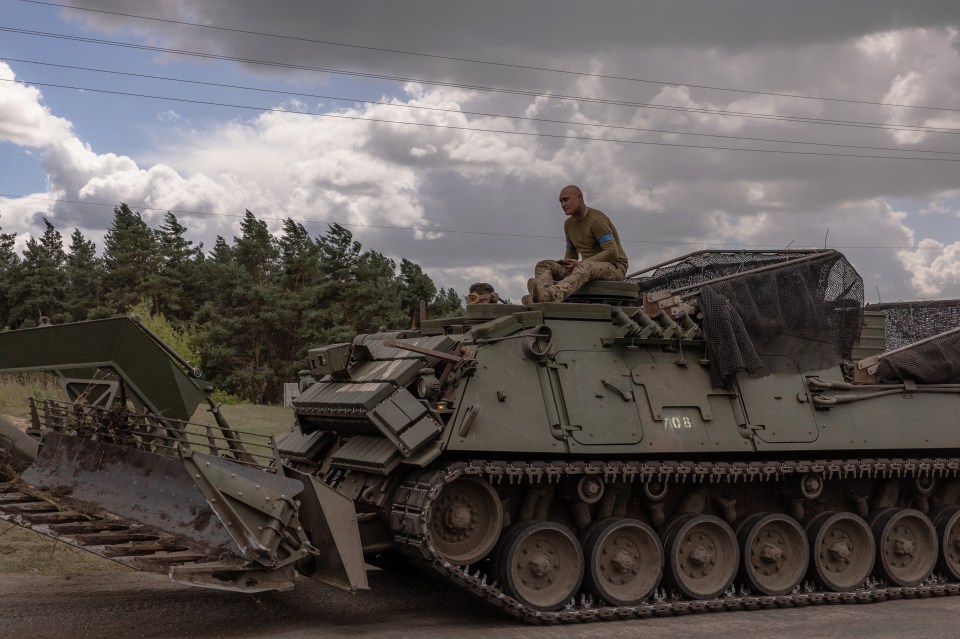 Ukrainian soldiers operating an armored military vehicle.